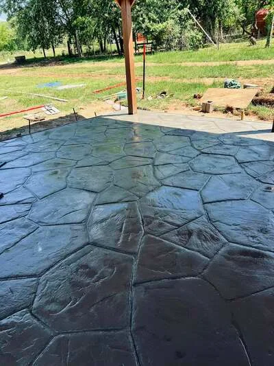Stamped concrete patio with slate pattern and charcoal finish, showing jointing detail