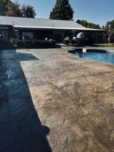Stamped concrete pool deck with spa, natural stone pattern finish