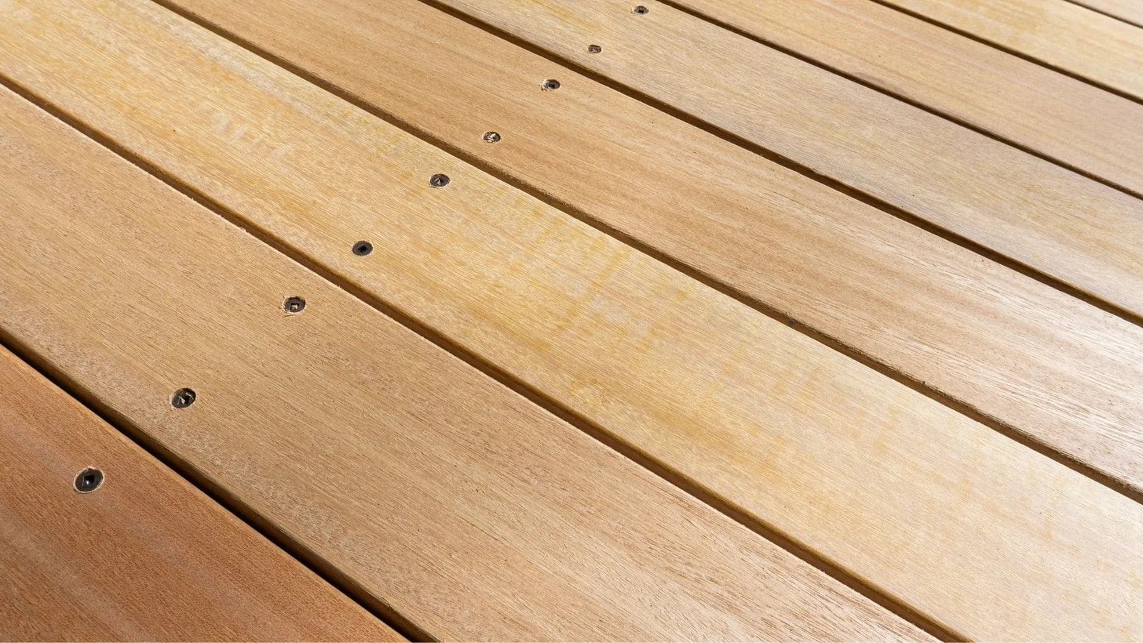 Diagonal composite deck boards with stainless steel fasteners, warm tan finish